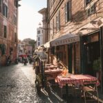 carriage and table on store front beside houses