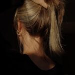 a woman with her hair in a bun