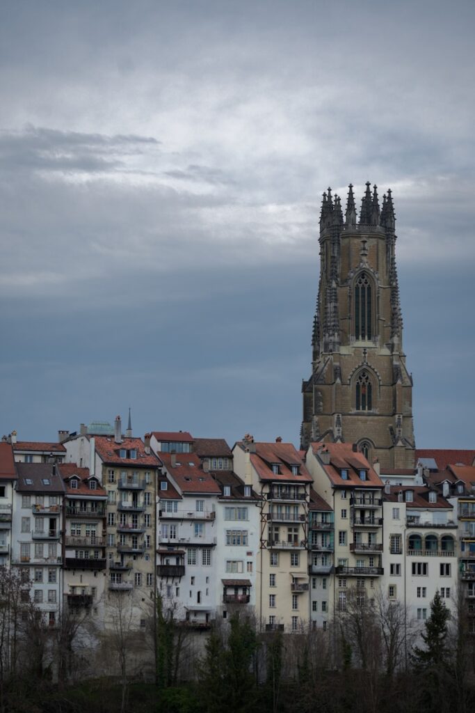 a very tall building with a clock tower in the background